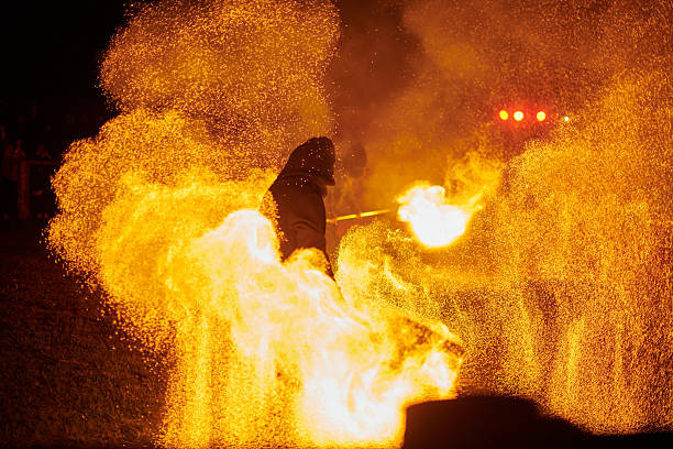 istock Silhouette of Two Fire Performers Creating Sparks Against Night field 2244445268