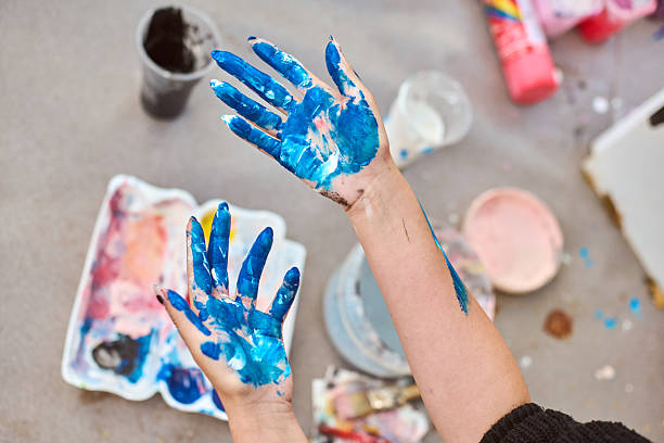 istock Vibrant colors on artists hands in outdoor setting 2244445323
