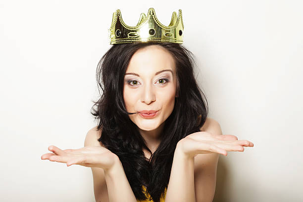 Young pretty brunette woman wearing crown