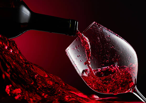 istock Red wine is poured from a bottle into a glass. 2244448715