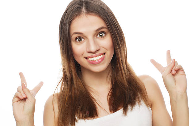 istock happy woman poiting finger up at copyspace isolated on a white 2244448949