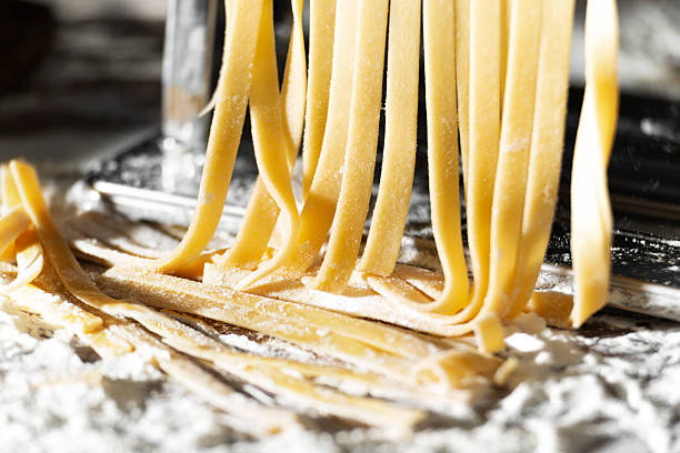 istock Fresh raw noodles made on home pasta machine closeup low angle view 2244449238