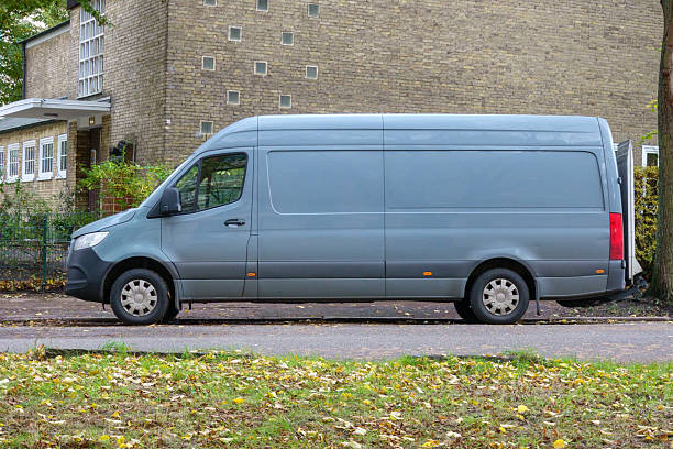 istock Parked delivery van side view with empty space for advertising in residential area 2244449312