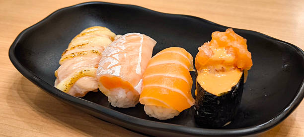 istock Sushi on a black plate on a wooden table 2244449622
