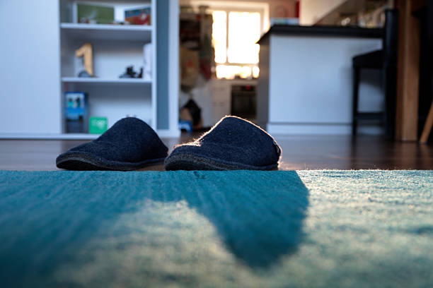 slippers in front of a carpet