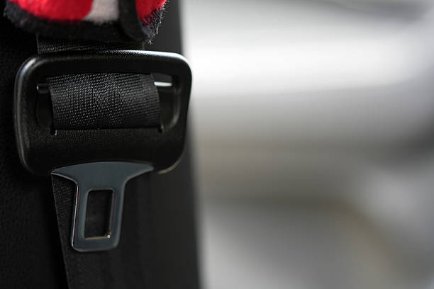 A close up photograph of a modern car seatbelt buckle.