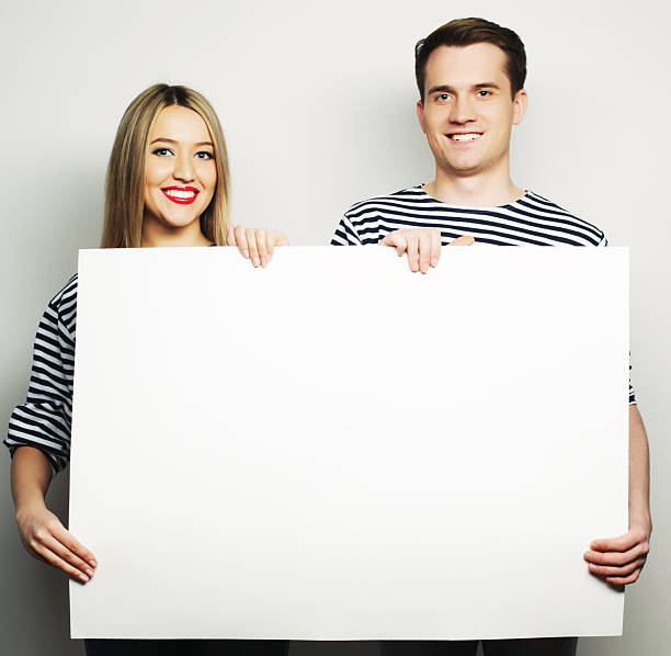 istock Couple holding a banner 2244454259
