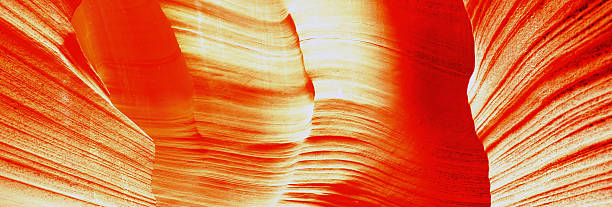 Natural, magical light beam illuminates the inside of Antelope Canyon . Abstract shapes and warm colors create a dramatic interior desert scene in the early morning light. Antelope Canyon, Page, Coconino County, Arizona, United States, North America