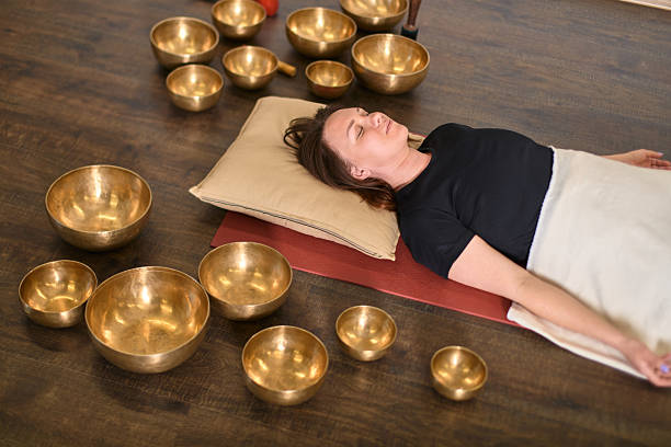 istock Relaxation ritual with singing bowls on wooden floor 2244459314