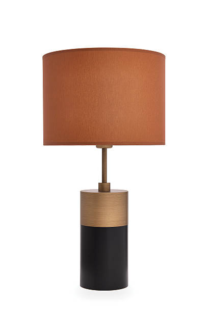 istock Modern table lamp with a cinnamon color lampshade and elegant black and brass base, designed for stylish home decor and interior lighting. This contemporary lamp is ideal for bedrooms, living rooms,office 2244462492