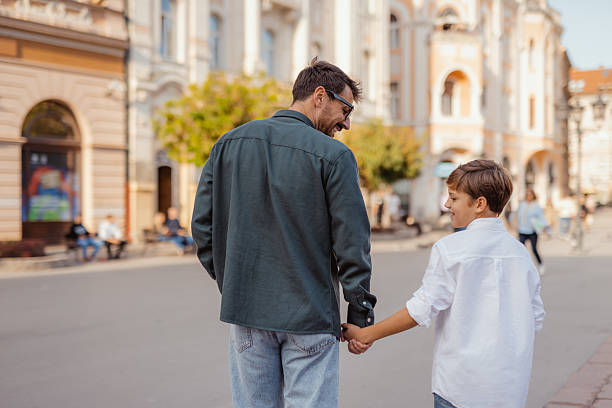 istock Back View of Father and Son Exploring Old Town 2244463634