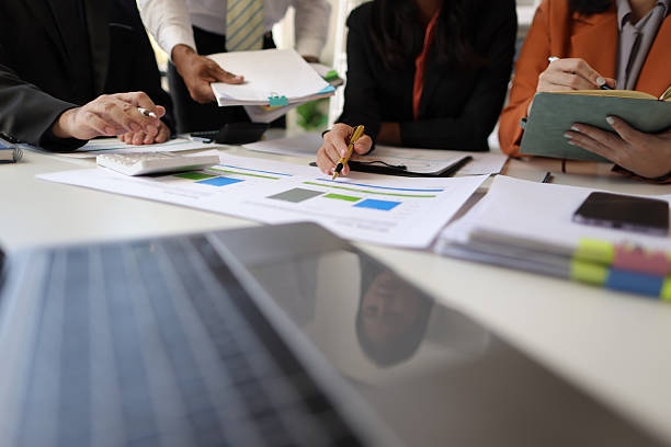 istock Business consultant analyzing statistics, charts and graphs discussing financial report. 2244463666