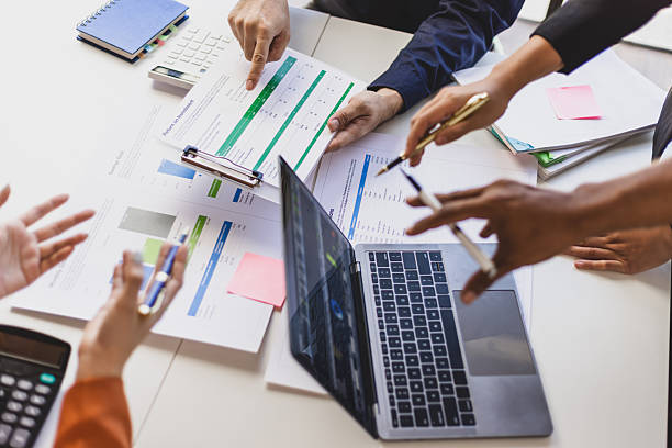 istock Business team analyzing financial charts and data on a laptop and documents, discussing strategies. 2244463698