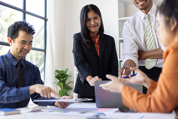 istock Asian businesspeople having meeting using laptop and documents in office, working together on a project, presentation and discussing strategy. 2244463711
