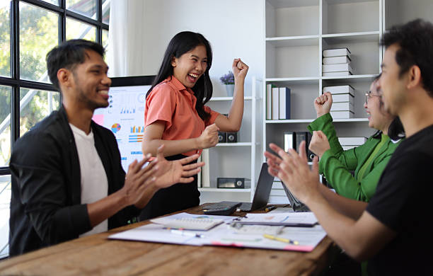istock Excited business team celebrating successful startup project in office meeting. 2244464459