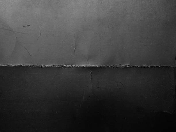 istock High-resolution texture of gray paper or cardboard featuring a clear cross-fold pattern with natural creases and light scratches. 2244465558