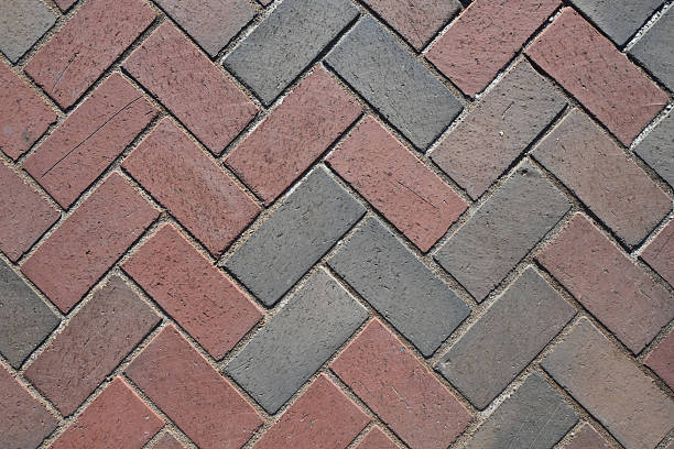 istock Close-Up View of Paver Bricks Laid in a Detailed Herringbone Pattern on a Walkway 2244466243