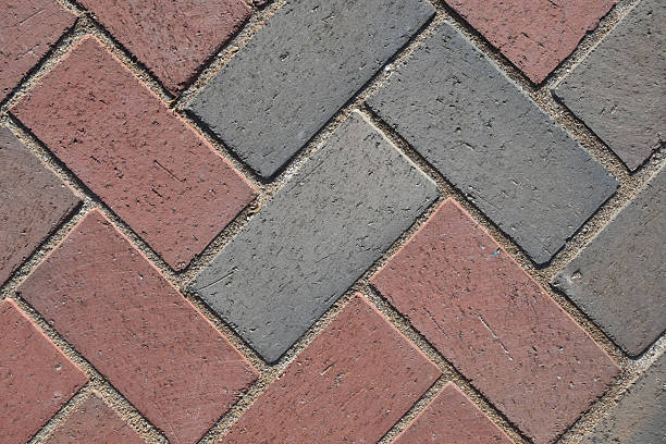 istock Close-Up View of Paver Bricks Laid in a Detailed Herringbone Pattern on a Walkway 2244466244