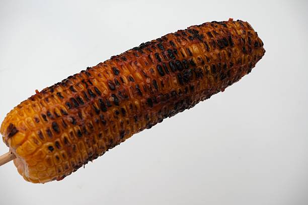 istock Grilled corn on the cob on white background 2244466288