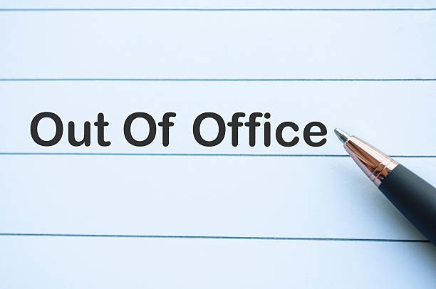 istock Out of office text on yellow notepad with on white notebook. Getaway or on a vacation concept. 2244470860