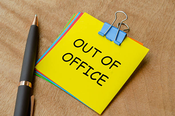 istock Out of office text on yellow notepad. Away from work or getaway concept. 2244471764