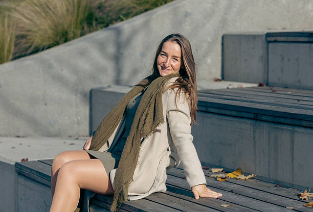 Caucasian young female with long hair smiling outdoors