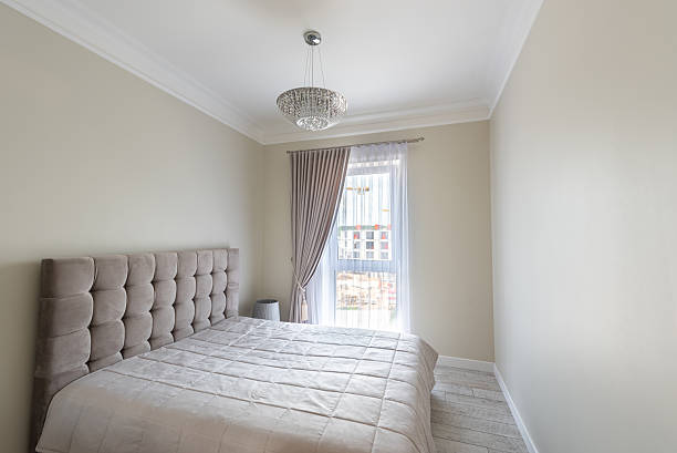 istock Modern Home Minimalist Bedroom Interior with Elegant Upholstered Bed and Window Light 2244474250