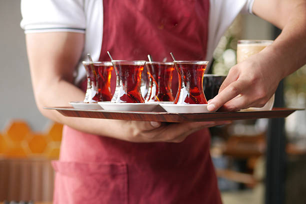 istock Waiter serves traditional tea at a cozy cafe 2244476241