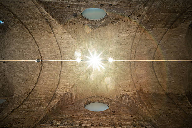 Seville's Atarazanas has a restored 13th-century brick ceiling with barrel vaults and circular windows, highlighting medieval architecture.