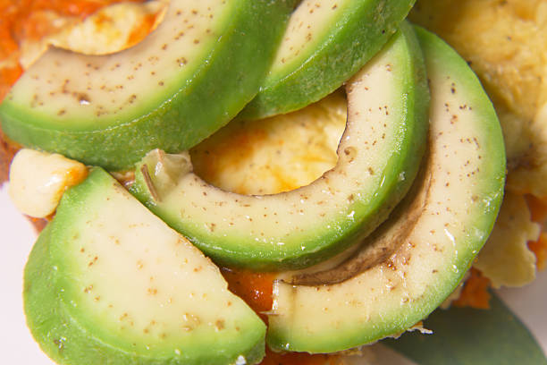 Tasty avocado slices enhance a colorful and vibrant meal.