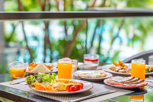 istock Tropical outdoor breakfast setting with fresh omelet, orange juice, 2244484959