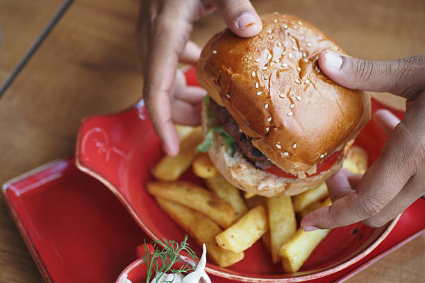 istock Enjoying a freshly made burger with fries at a cozy eatery 2244489848