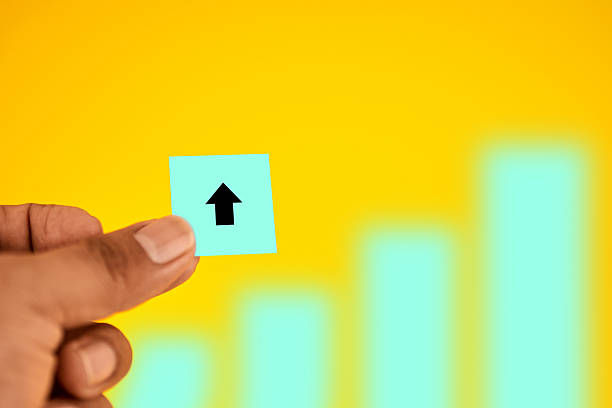 Hand presenting an upward arrow with growth bars, conveying progress, performance improvement and rising business results through clear, data-driven momentum.