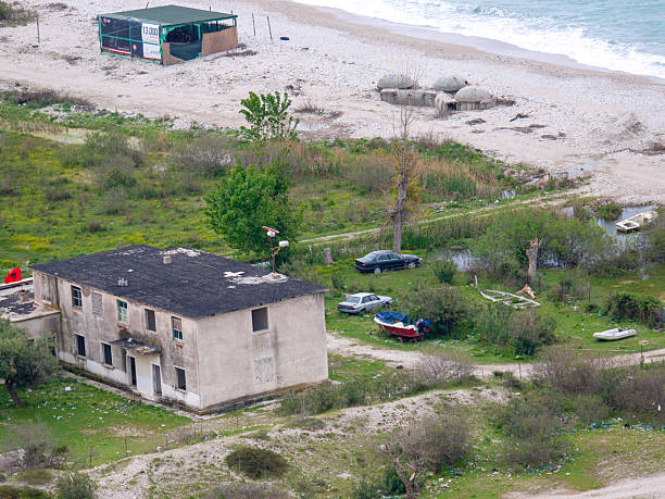 Detail of coexistence of old bunkers and new tourism development on beach of the Adriatic coast in Albania. All across the Albania there are approximately 700 000 bunkers from communist times.  Most in ruins.