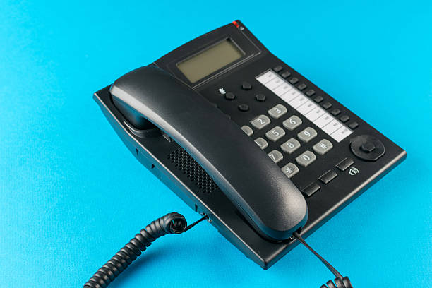istock Vintage Black Office Landline Phone on Vibrant Blue Background - A Retro Communication Device 2244504629