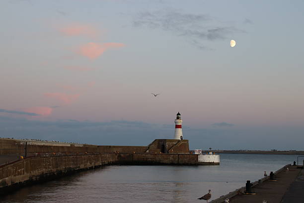 Fraserburgh, Aberdeenshire, Scotland - November 1, 2025:  The red and white beacon on the breakwater of Fraserburgh harbour at dusk