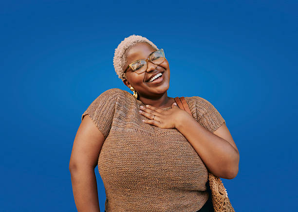 istock Young Creative African American Woman Smiling Joyfully Against Solid Blue Background 2244510742