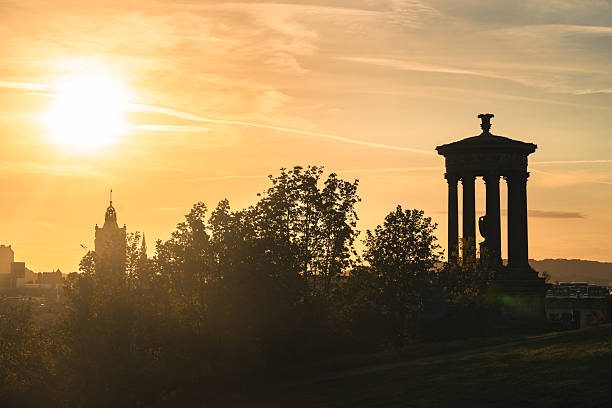 Edinburgh, Scotland - Jan 18, 2024 - A view of the of National Monument of Scotland and Nelsonâs of Monument situated with a bright blue sky in the background on Calton Hill at Edinburgh city. Exterior architecture on Calton Hill, Scotland, Space for text, Selective focus.