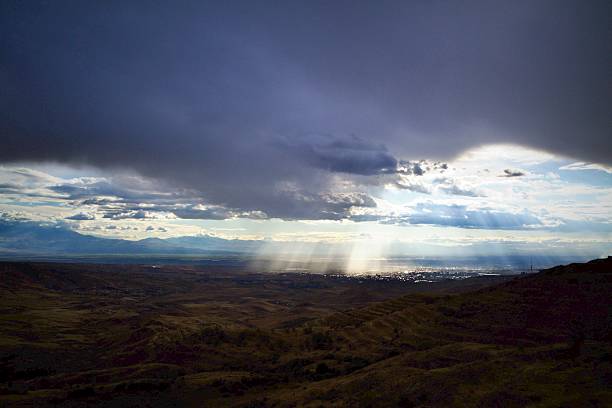 istock Break in the storm: sunbeams over the valley 2244513168