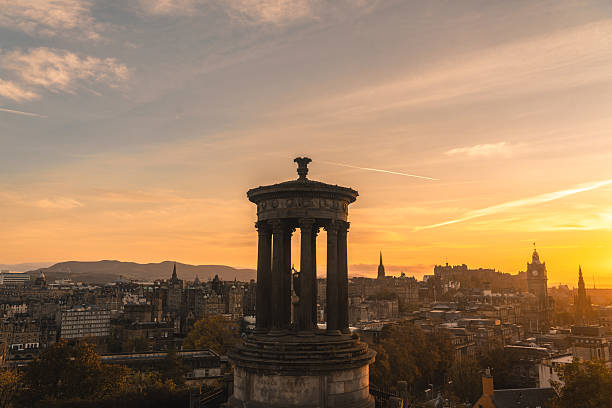 The sun rising behind Calton Hill, seen from the Royal Mile in Edinburgh. The Nelson Monument, seen in the upper-left, was built in 1815 to commemorate Vice Admiral Horatio Nelson’s victory over the French and Spanish fleets at the Battle of Trafalgar in 1805, and his own death in that battle.