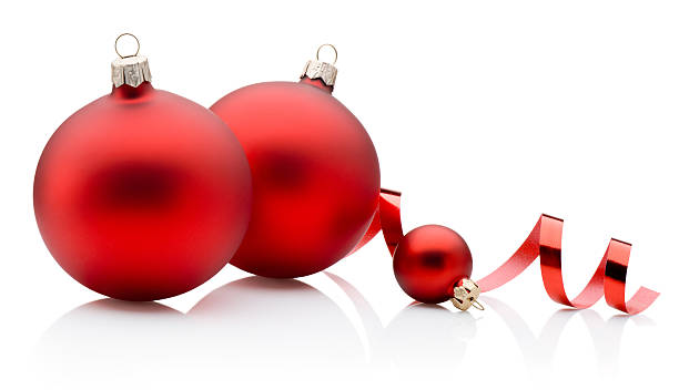 istock Three red Christmas baubles and curling paper ribbon isolated on white background 2244513986