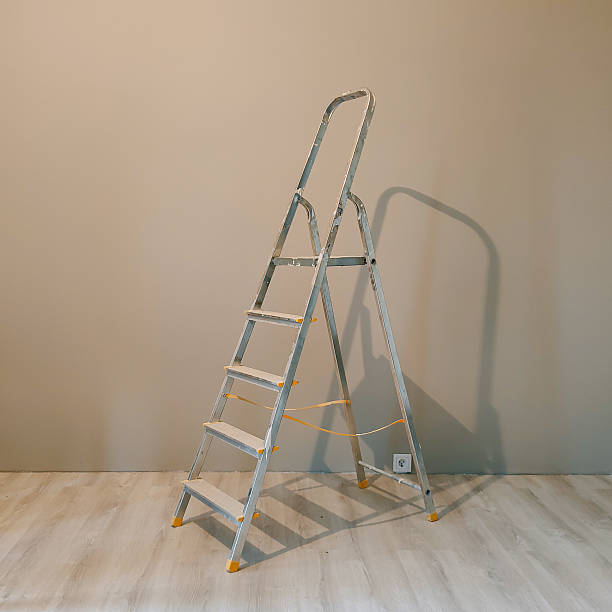 istock Aluminum a-frame ladder in a nearly empty beige room 2244514117