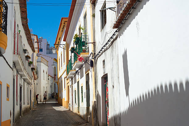 People on a typical old town street in Beja, Portugal