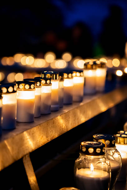 istock Lit grave candles illuminating a dark scene on All Saints' Day 2244524367