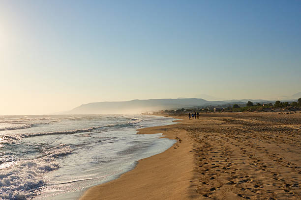 istock Serene beach landscape with gentle waves lapping against sandy shore under clear blue sky, inviting relaxation and tranquility in nature's beauty 2244525378