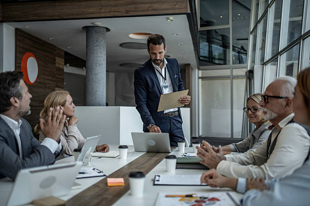 istock Business man presenting during corporate meeting with multi-generation team 2244525820