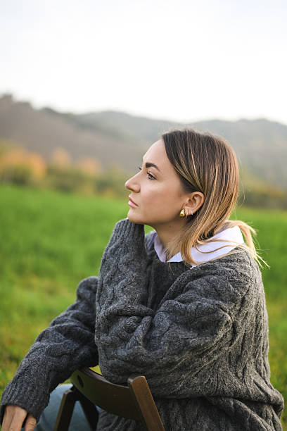 istock Woman thinking sitting in nature looking away 2244528205