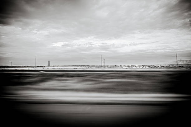 istock Black and white abstract views from Interstate 80 between Salt Lake City and Wendover, showing vast desert landscapes, salt flats, distant mountains, and minimal traffic along the isolated highway corridor. 2244531618