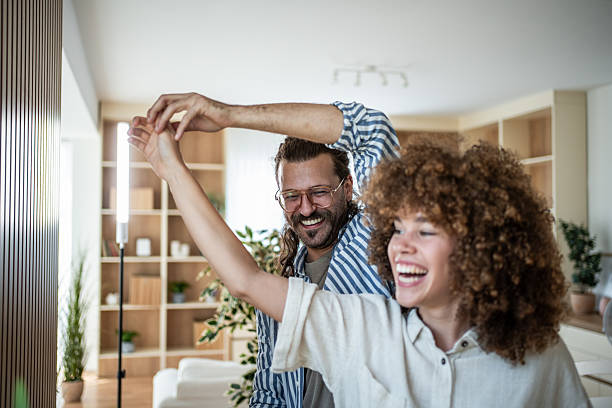 istock Happy couple dancing and laughing together at home 2244532855