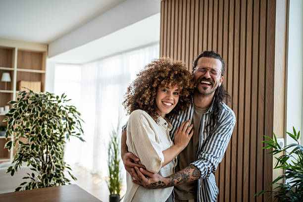 istock Happy mixed race couple hugging smiling at home 2244533108